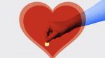large read heart with hand holding coin